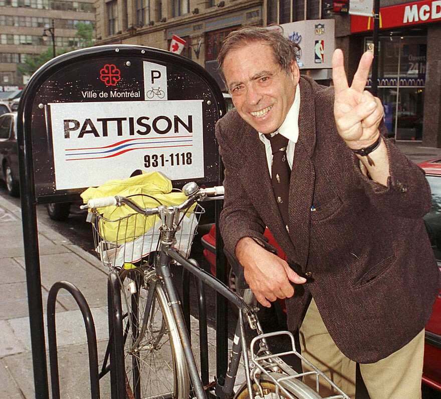 Robert (Bicycle Bob) Silverman shows a victory symbol after a successful campaign to get bicycle racks installed on Ste-Catherine St. on Aug. 26, 1998. Tedd Church Montreal Gazette files