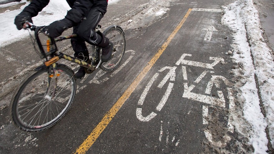 A cyclist makes his way down a bike path in Montreal Tuesday, February 17, 2015. Despite frigid temperatures and slippery roadways, winter cycling continues to grow in popularity. THE CANADIAN PRESS/Paul Chiasson