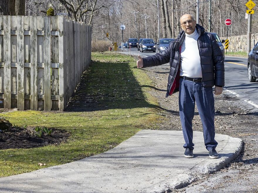 "On such a busy boulevard, the sidewalk on the south side is not a luxury, it is a necessity," says Bachir Azzi, seen standing on the sidewalk curve that will be removed, along with several feet of his property, on the corner of Gouin Blvd.
