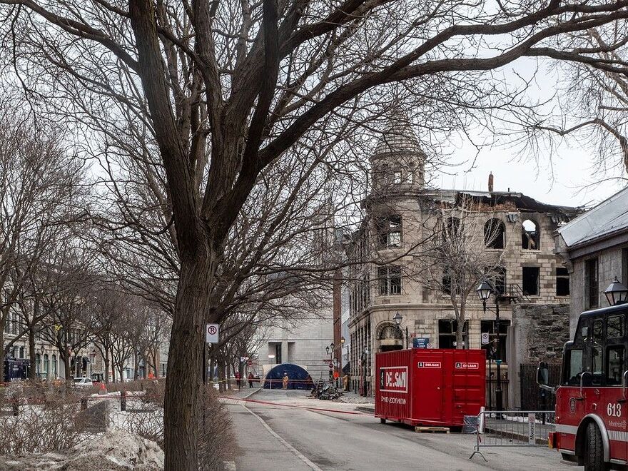 Firefighters continued to investigate the scene of the fire in Old Montreal on Tuesday. Two bodies had been found, but five people were still missing.