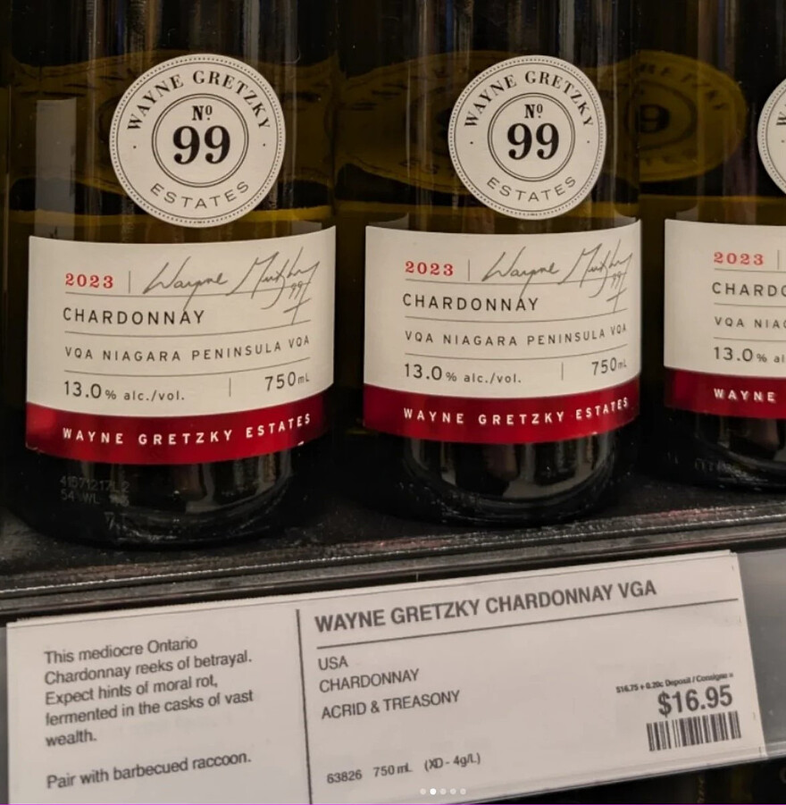 Bottles of Wayne Gretzky Chardonnay labelled "USA. Chardonnay. Acrid & treasony." Product description: "This mediocre Ontario Chardonnay reeks of betrayal. Expect hints of moral rot, fermentedin the casks of vast wealth. Pair with barbecued raccoon." $16.95.