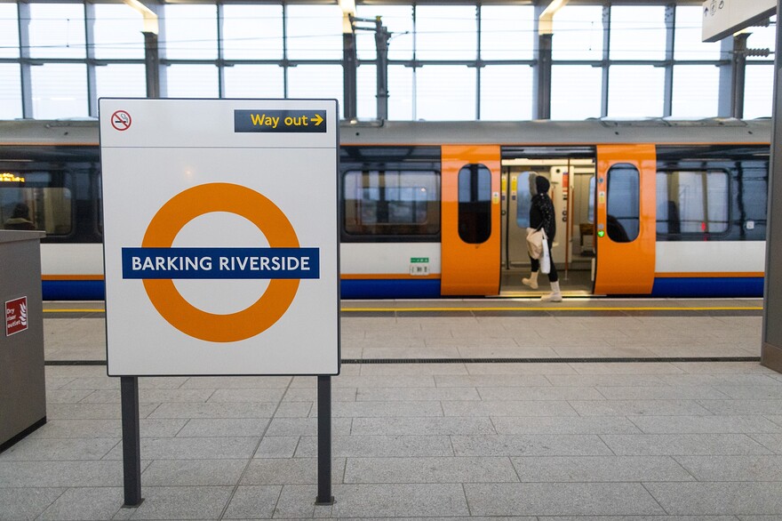 A commuter boards a train at Barking Riverside overground station in London.