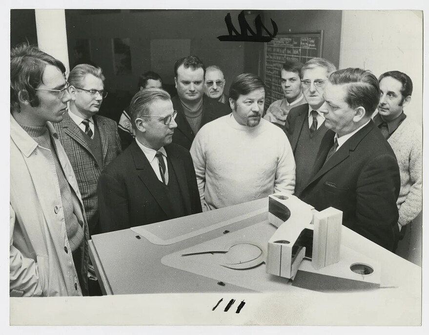 PCF officials Gaston Plissonnier (center, in glasses and dark suit) and Georges Gosnat (far right) gather around an architectural model of the party headquarters.Photo: Michel Moch/SIAF/CAPA/© Archives d’architecture contemporaine/ADAGP