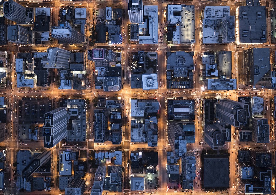 An aerial image of the downtown of Chicago with building illumination at dusk.
