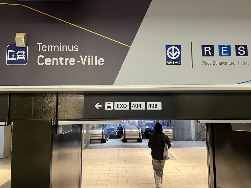 Sign between Le 1000 and Place Bonaventure, with exo buses pointing left being added below