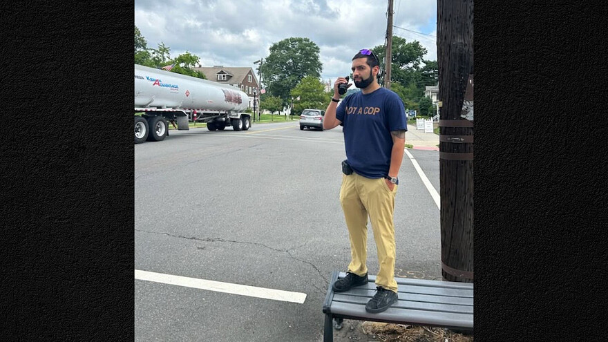 A Dunellen police officer wears a shirt that reads "not a cop" during the department's distracted driving enforcement operation on Wednesday, July 29, 2026. ©Dunellen Police Department