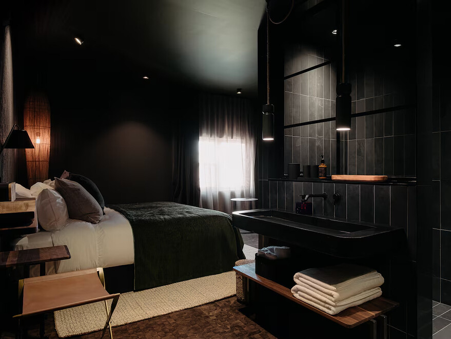 The ensuite in one room is separated from the rest of the space by an awkwardly placed black sink and vanity. — MATDEROME/Supplied