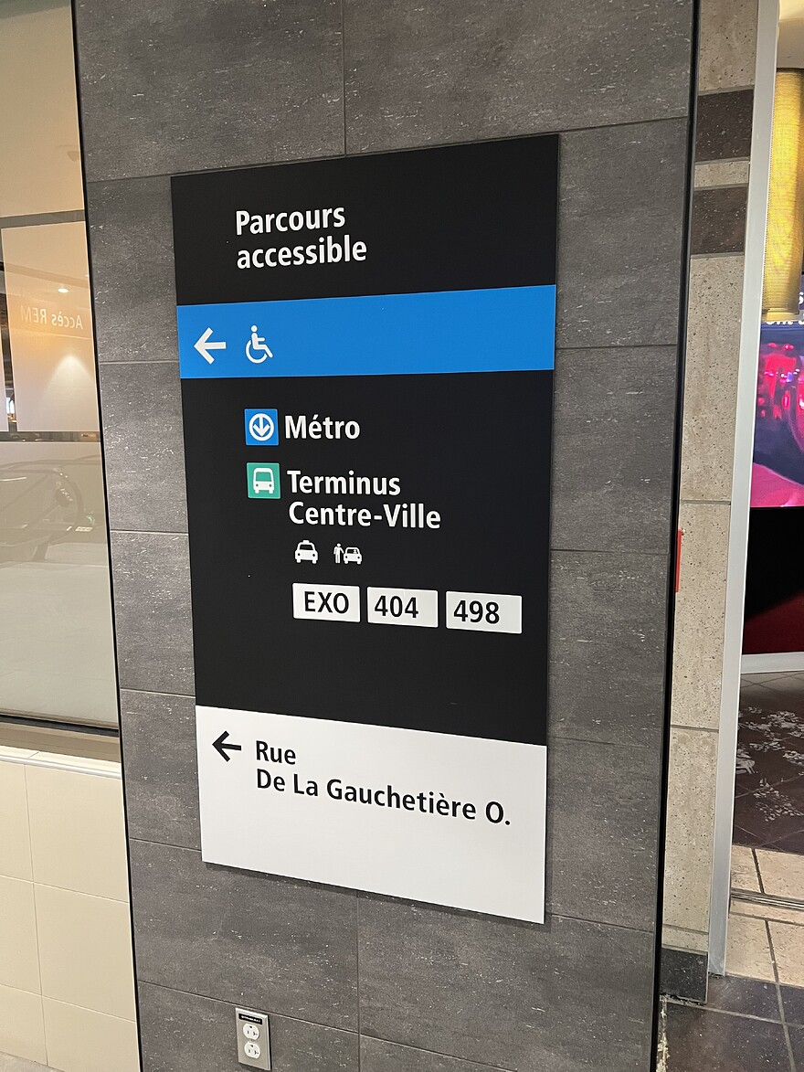 Sign on pillar near REM staircase in Gare Centrale