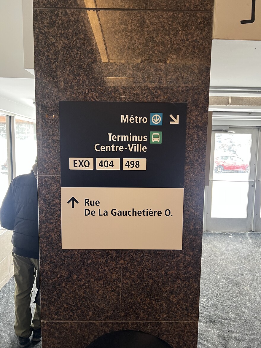 Sign on pillar at Gare Centrale near the doorway on Rue De La Gauchetière