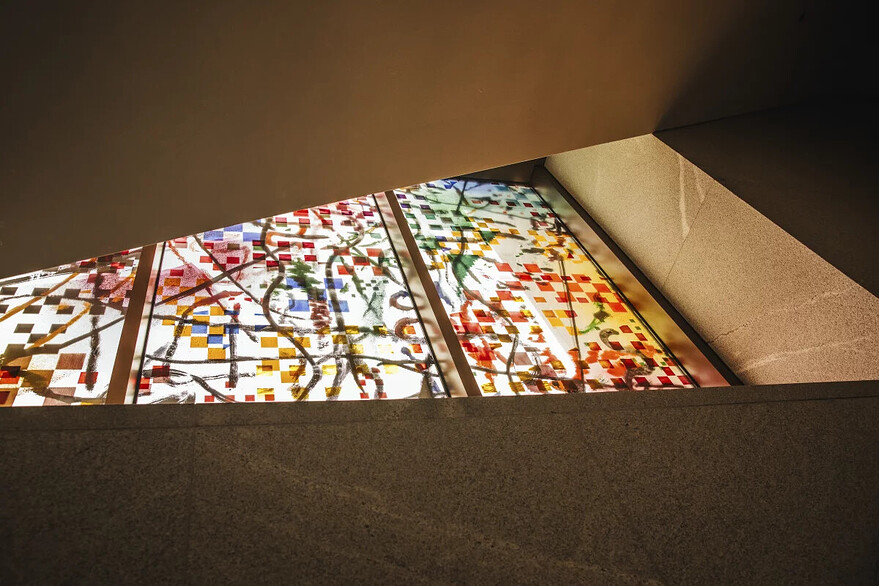 Visitors can catch glimpses of Julie Mehretu's layered glass artwork while riding the escalators between floors. - Lucy Hewett for NPR