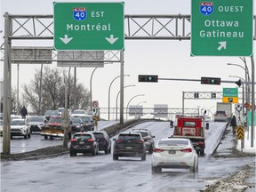 Vehicles and pedestrians pass on St-Jean Blvd. over Highway 40 in Pointe-Claire on Tuesday. Reconstruction of the overpass is scheduled for 2023.