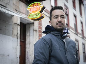 Jonathan Cha is seen in front of the Wing’s noodle factory in Chinatown on Friday, April 23, 2021. The building was originally the British and Canadian School, designed by James O’Donnell, best remembered as the architect of Notre-Dame Basilica.