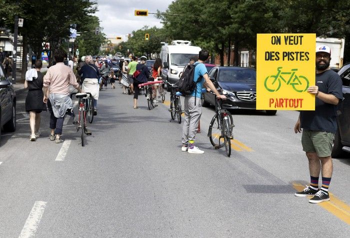 Bicycle activists close one lane of Parc Ave. during Vélo fantôme Québec event on Saturday, July 22, 2023.