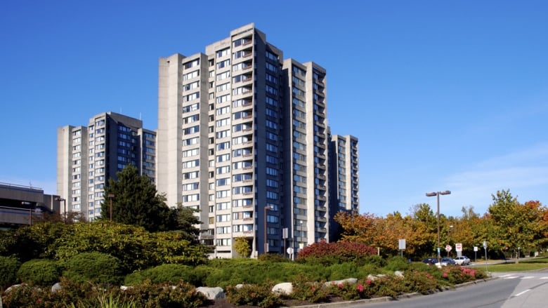 A multi story residential building shown against a blue sky