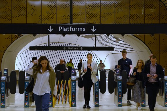 Commuters pass through the new Victoria Cross metro station’s ticket gates.
