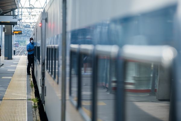 A conductorboards a train at the Metro-North station in Stamford, Connecticut.