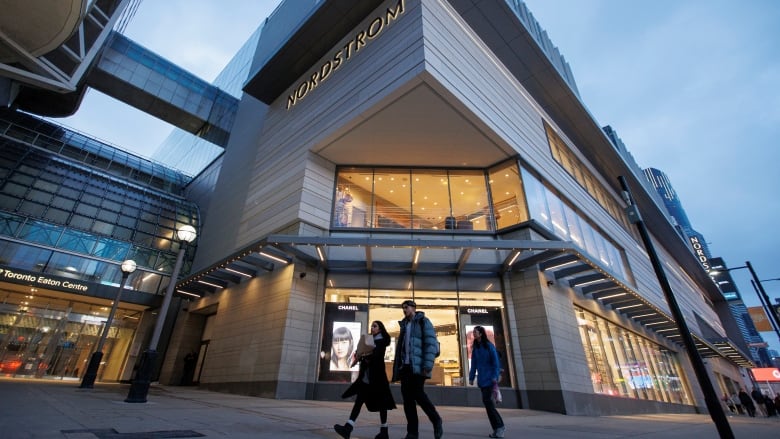 Shoppers walk past a Nordstrom store in Toronto