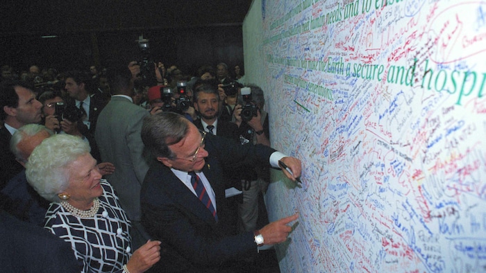 Le président des États-Unis George Bush alors qu'il signe l'engagement pour la Terre lors du Sommet de la Terre à Rio de Janeiro, le 12 juin 1992.