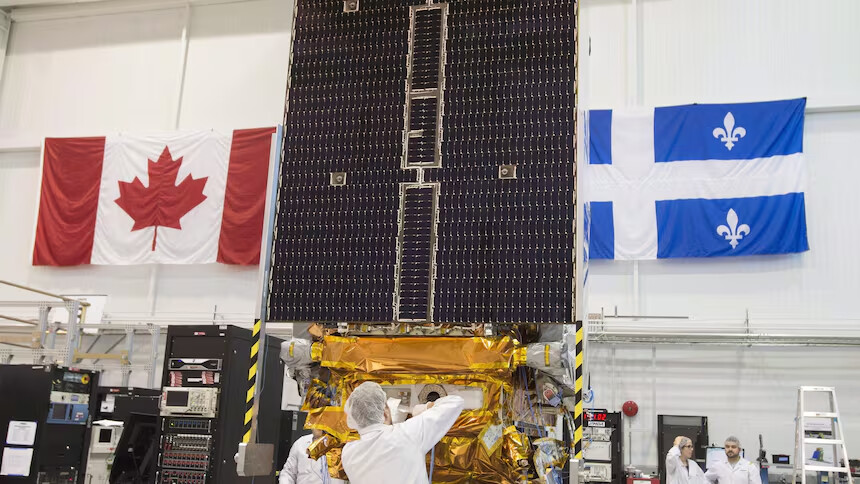Technicians put the final touches on the second of three RADARSAT Constellation Mission satellites at the MDA facility in Montreal, before their launch into space aboard a SpaceX rocket from Vandenberg Air Force Base in California on June 12, 2019. (Ryan Remiorz/The Canadian Press)