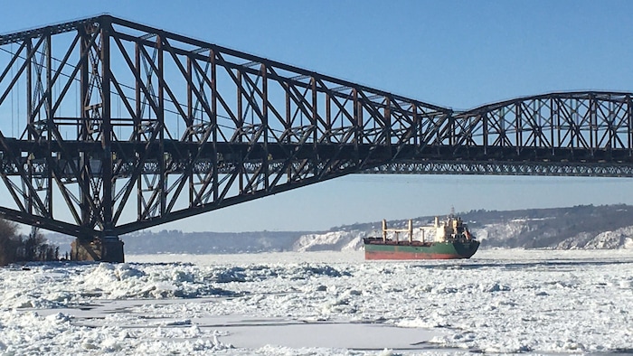 Un bâteau passe sous le pont de Québec.